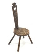 20th century oak spinning chair, relief carved with flower head, s scrolls and leafage, pierced hear