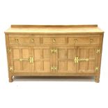 'Eagleman' adzed oak dresser, three drawers above two double cupboards enclosed by four panelled doo