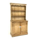 Victorian pine dresser, two heights plate rack above double panelled cupboard, plinth base, W109cm,