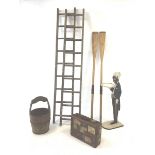Two pairs of vintage wooden ladders, wooden and metal bound bucket, two vintage rowing awes, blackmo