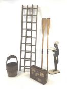 Two pairs of vintage wooden ladders, wooden and metal bound bucket, two vintage rowing awes, blackmo