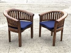 Pair teak garden armchairs, curved backs and serpentine slatted seats, with seat cushions, W84cm