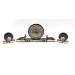 French Art Deco clock garniture, the marble, onyx and black slate clock surmounted by two bronzed me
