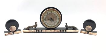 French Art Deco clock garniture, the marble, onyx and black slate clock surmounted by two bronzed me