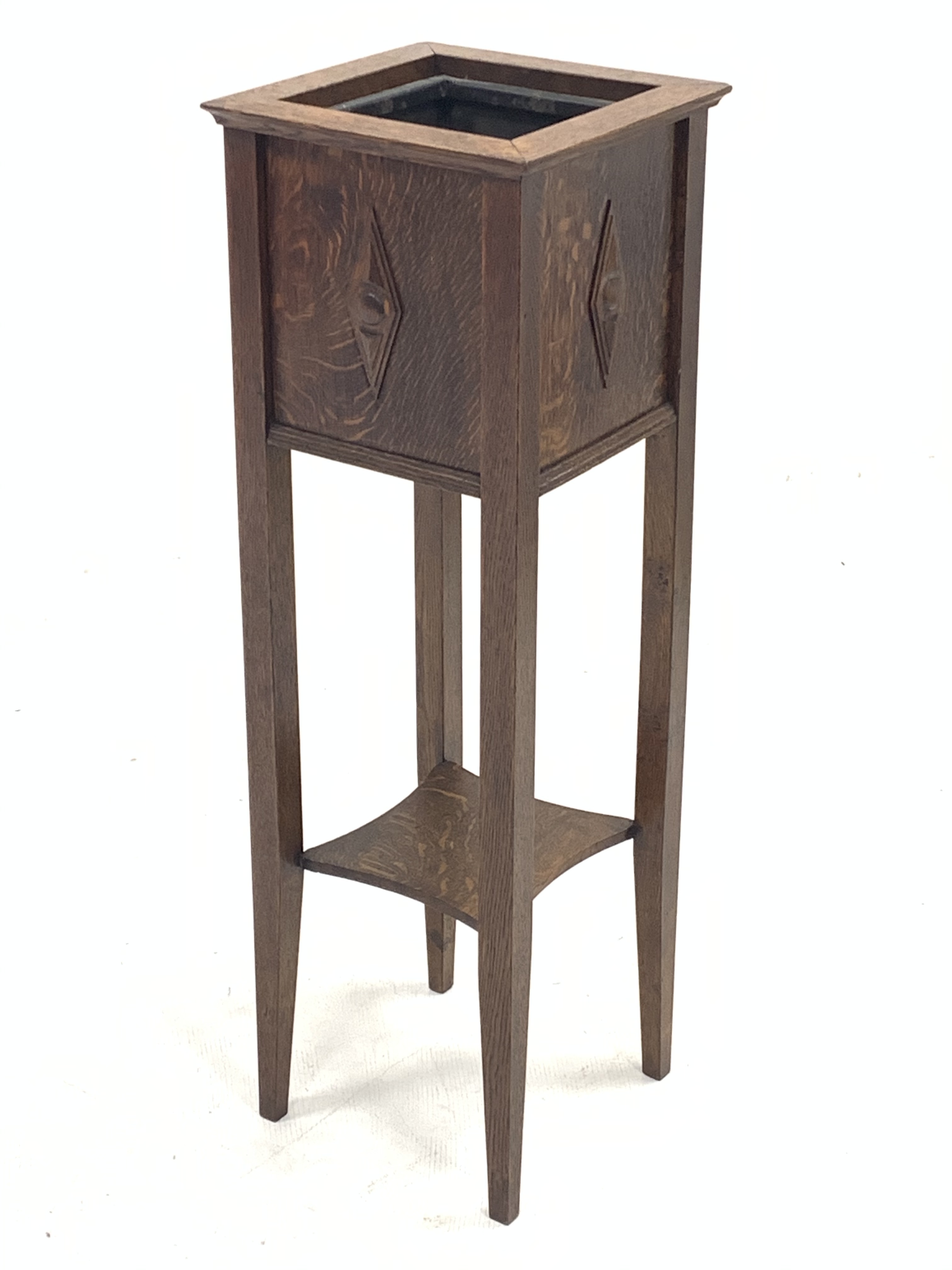 Early 20th century oak square plant stand with metal liner, the sides decorated with stepped lozenge