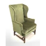 20th century Georgian style wing back armchair upholstered in green fabric, W79cm