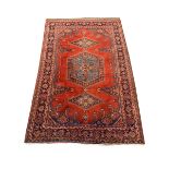Persian rug carpet, red field with blue medallion and two lozenge medallions, guarded border decorat
