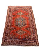 Persian rug carpet, red field with blue medallion and two lozenge medallions, guarded border decorat