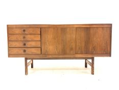 Mid 20th century hardwood veneered sideboard with four drawers flanking cupboard enclosing shelves,