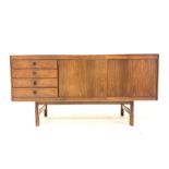 Mid 20th century hardwood veneered sideboard with four drawers flanking cupboard enclosing shelves,