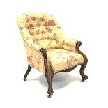 Victorian rosewood armchair, scrolled arms supports and carved cabriole feet on brass castors, uphol