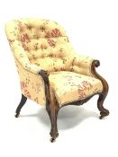 Victorian rosewood armchair, scrolled arms supports and carved cabriole feet on brass castors, uphol