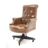 20th century captains swivel armchair, upholstered in deep buttoned studded brown leather, raised on