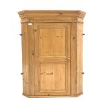 Solid pine wall hanging corner cabinet, panelled door enclosing two shaped fixed shelves, W83cm, 1