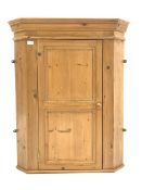 Solid pine wall hanging corner cabinet, panelled door enclosing two shaped fixed shelves, W83cm, 1