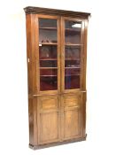 19th century mahogany floor standing corner cupboard, dentil cornice over two glazed doors enclosin