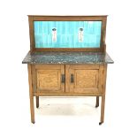 Arts & Crafts period oak washstand with grey and white marble top and light blue tiled back with two