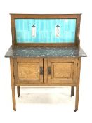 Arts & Crafts period oak washstand with grey and white marble top and light blue tiled back with two