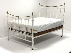 Early 20th century iron and brass 4' 6'' double bedstead, curved brass rails and urn shaped finials,