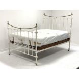 Early 20th century iron and brass 4' 6'' double bedstead, curved brass rails and urn shaped finials,