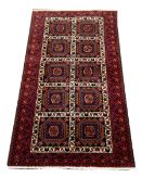 Persian rug, blue ground with ten square plates with geometric design, 185cm x 100cm