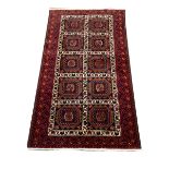 Persian rug, blue ground with ten square plates with geometric design, 185cm x 100cm