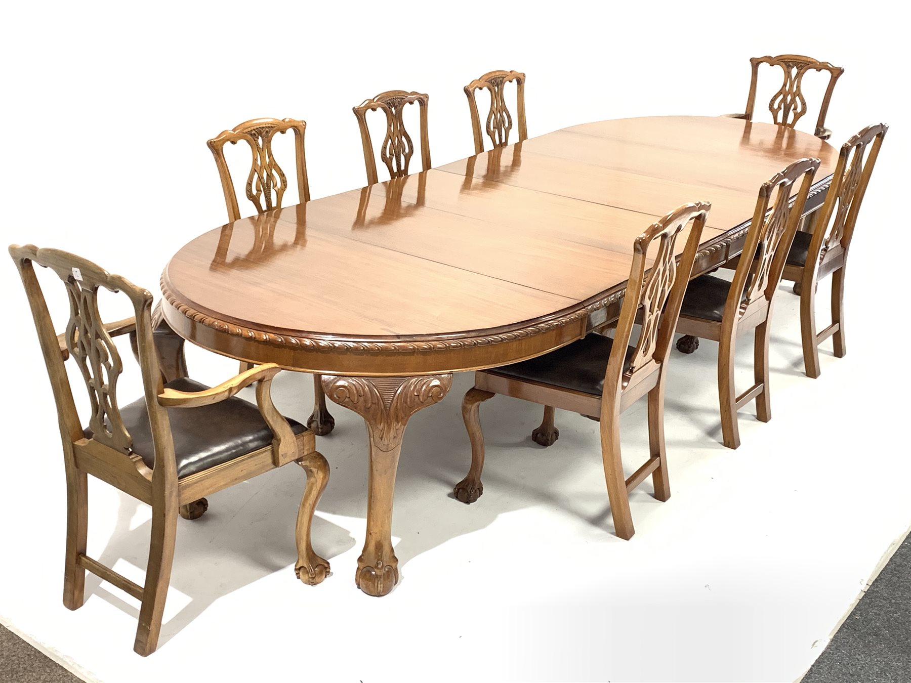 Early 20th century mahogany dining table, oval gadroon carved telescopic extending top with four add