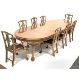 Early 20th century mahogany dining table, oval gadroon carved telescopic extending top with four add