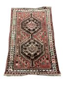 Persian hand knotted red ground rug with double pole medallion, field decorated with stylised motifs