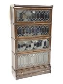 Early 20th century oak four tier stacking library bookcase enclosed by lead glazed doors, drawer to