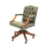 Reproduction mahogany swivel captains desk chair, upholstered buttoned back in green leather with st