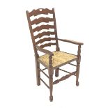 Late 20th century mahogany farmhouse style carver armchair, waved ladder back and rush seat, total w