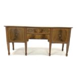 Georgian design mahogany serpentine sideboard, with cross banded top over two drawers and two cupbo