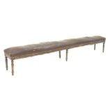 19th century French beech framed long bench, seat fully sprung and upholstered in leather, on turned