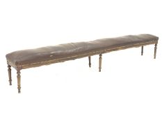 19th century French beech framed long bench, seat fully sprung and upholstered in leather, on turned