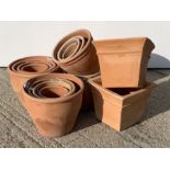 Twenty circular terracotta plant pots with rope twist rims and four square tapering terracotta plant