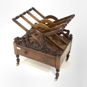 Victorian walnut three division Canterbury, with floral and ribbon carved decoration to each end, r