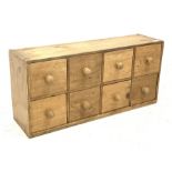 Small pine chest fitted with eight drawers, W76cm, H36cm, D21cm