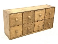 Small pine chest fitted with eight drawers, W76cm, H36cm, D21cm