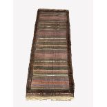 Turkish flat weave red ground rug with multi coloured stripped design and tufted border, 141cmx 37