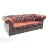 Late 20th century three seat chesterfield sofa upholstered in deeply buttoned red leather, W225cm, D