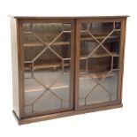 Edwardian mahogany Georgian style library bookcase enclosed by two astragal glazed sliding doors, si