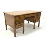 Mid 20th century oak twin pedestal desk, with one long drawer flanked by slides and five short drawe
