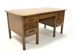 Mid 20th century oak twin pedestal desk, with one long drawer flanked by slides and five short drawe