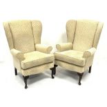 Pair traditional shaped wingback armchairs upholstered in neutral fabric, W75cm