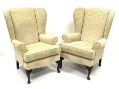 Pair traditional shaped wingback armchairs upholstered in neutral fabric, W75cm