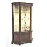 Early 20th century mahogany break bow front display cabinet, astragal glazed door enclosing three gl