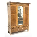 Early 20th century panelled oak wardrobe, projecting cornice over single bevel edged mirror glazed d