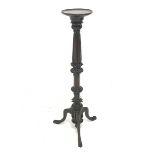 Early 20th century mahogany Gothic torchere, circular top sat upon foliage carved, reeded and fluted