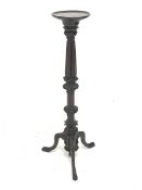 Early 20th century mahogany Gothic torchere, circular top sat upon foliage carved, reeded and fluted